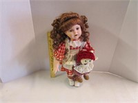 Beautiful Porcelain doll on stand holding a doll