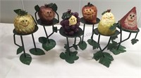 Six Decorative posing fruit candles on metal