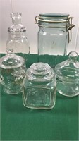 Variety of decorative clear glass jars with lids