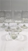 Four monogrammed “M” wine glasses and one shot
