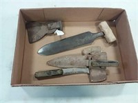 assortment of hatchets and knives