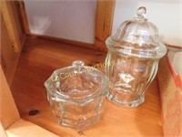 2 covered glass containers