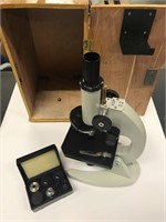 Microscope and locking box with extra lenses