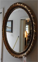 Oval gold framed mirror (26” x 35”)