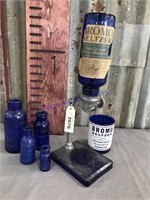 Bromo Seltzer bottles and stand