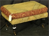 UPHOLSTERED OTTOMAN ON BRASS CASTERS