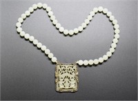 Chinese carved jade necklace and a silver mounted