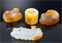 Three Chinese carved agate toggles and a archer's