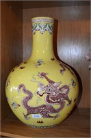 Large Chinese vase with dragons on a yellow