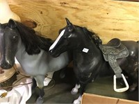 2 large plastic horses one with saddle