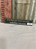 Redefine success tin sign