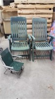 two sturdy plastic lawn chairs and child's