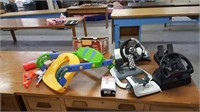 assorted lot of video game controllers and toys