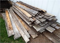 Pile of Barn Board Lumber & Round Posts