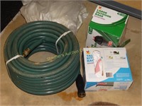 Garden hose - new & 2 open boxes of garbage bags