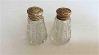PAIR OF CRYSTAL SALT + PEPPERS WITH STERLING TOPS