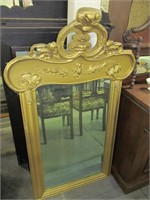 Gold framed mirror, carved top