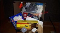 Box of light bulbs and plastic utensils