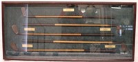 FRAMED COLLECTION OF 5 WOOD SHAFT GOLF CLUBS,