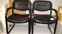 Pair of black leather armchairs