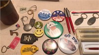 Assorted pins pens and buttons plus keychains