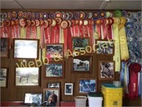 wall full of pictures, frames, and ribbons