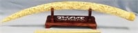 24" ornately carved ivory tusk with village scenes