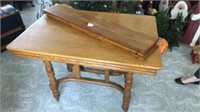 Oak dining room table with three leaves on casters