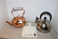 TWO TEA POTS AND CUTTING BOARD