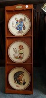 Hummel collectible plates and wood display shelf