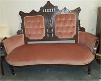 Antique parlor settee with carved walnut back