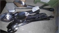 Lot of large serving spoons and meat hammer