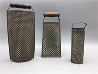 Three large tin ware graters