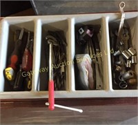 Tray filled with screw drivers, drill bits,