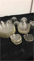 Group of apple shaped glass plates with cups