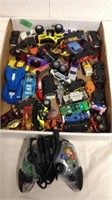 Group of toy cars and generic Xbox controller