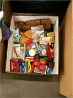 Box of baseball mitts and old toys knives Etc