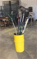 Barrel of lawn tools rakes, shovels, hoes, pitch