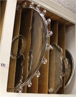 In slotted shelf: glass serving plates,
