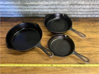 Three cast iron pans