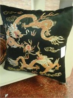 Black pillow with dragons on it