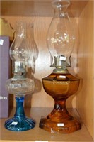 2 vintage kerosene lamps, one with an amber