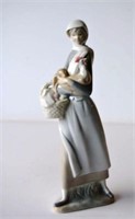 Lladro figurine of a young woman holding a chicken