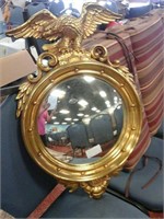 Gold frame mirror with an eagle on it