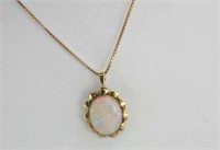 Good 9ct yellow gold solid white opal pendant