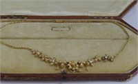 Boxed 14-15ct gold lavaliere set with seed pearls
