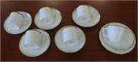 Five Susie Cooper cups with saucers