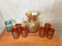 Carnival glass pitcher and glasses