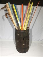 Small barrel filled with yard meter sticks.