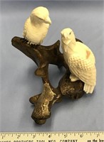 Two fossilized ivory carvings of eagles with carve